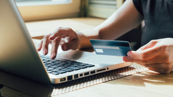 girl makes a purchase on the Internet on the computer with credit card