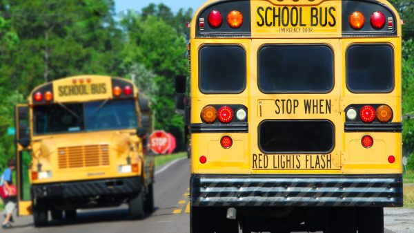 school bus on rural road picking up children