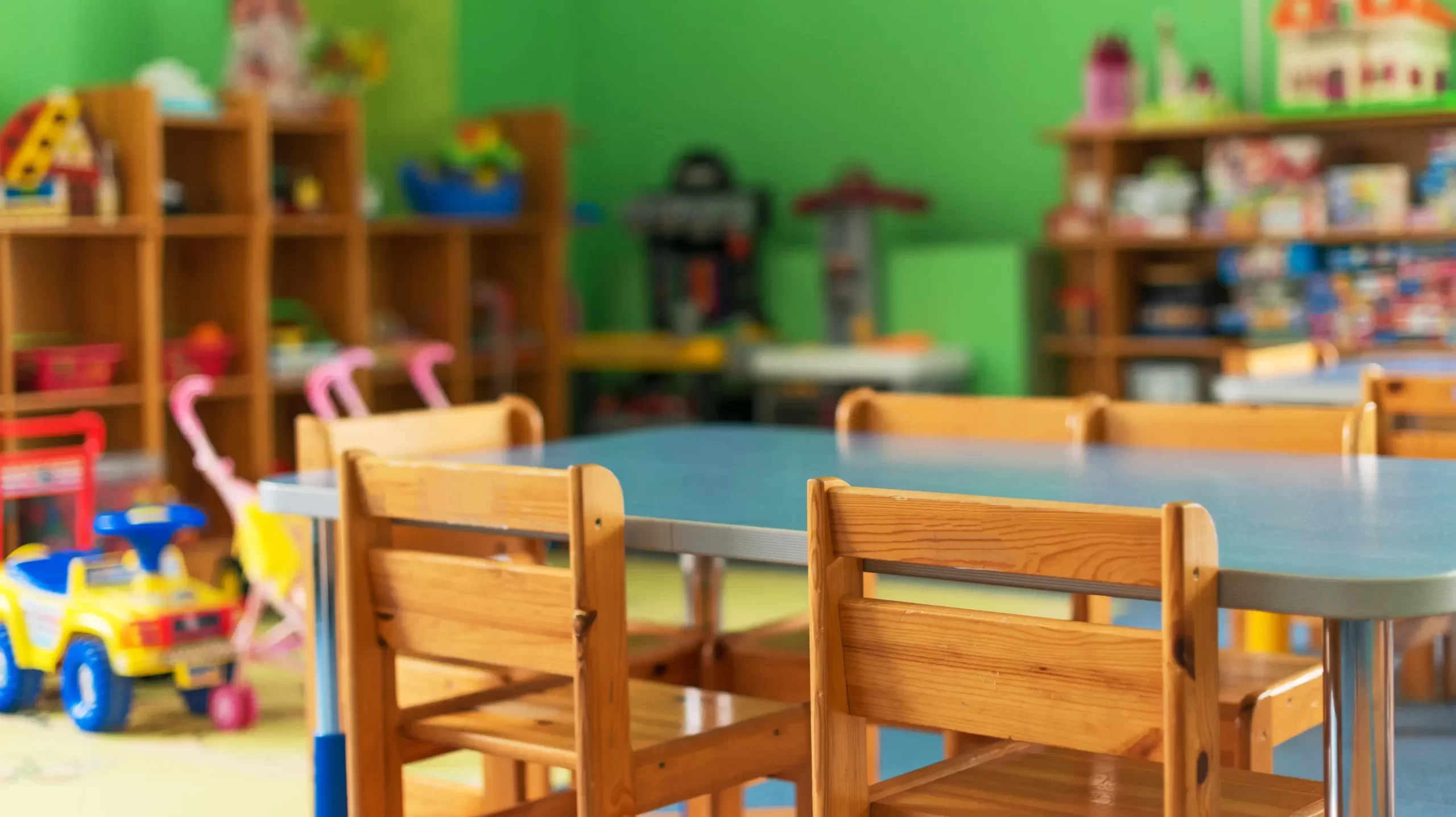 Chairs, table and toys. Interior of kindergarten.