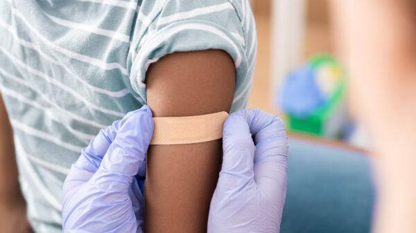 Doctor, medical and insurance with a child in a clinic for his vaccination.