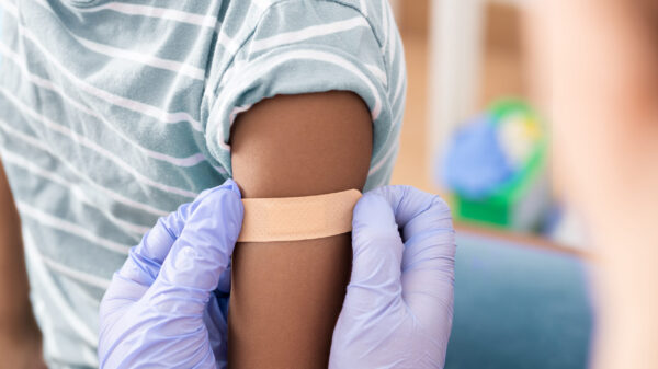 Doctor, medical and insurance with a child in a clinic for his vaccination.