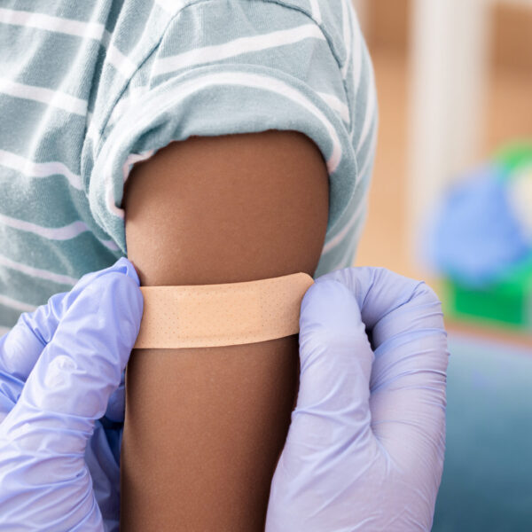 Doctor, medical and insurance with a child in a clinic for his vaccination.