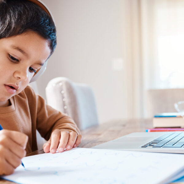 Learning headphones, math education and child in home with book for studying, homework or homeschool. Development, laptop or boy or kid with notebook for numbers in elearning, virtual or online class.